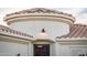 Arched stucco entrance features a wrought iron door and red tiled roof at 23318 N Las Positas Ct, Sun City West, AZ 85375