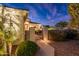 Private courtyard entrance with gated access and lush tropical landscaping for a secluded outdoor retreat at 23318 N Las Positas Ct, Sun City West, AZ 85375