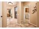 Bright hallway showcases tiled flooring, white door frames, and access to rooms at 23318 N Las Positas Ct, Sun City West, AZ 85375