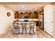 Well-lit kitchen featuring a center island with seating, stainless steel appliances, and tile flooring at 23318 N Las Positas Ct, Sun City West, AZ 85375