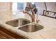 Close-up of kitchen sink featuring granite countertop and brushed steel faucet at 23318 N Las Positas Ct, Sun City West, AZ 85375