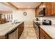 Kitchen featuring stainless appliances, granite counters, tile floor, and a view into the dining and living areas at 23318 N Las Positas Ct, Sun City West, AZ 85375