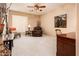 Inviting living room features neutral walls, carpet floors, and shuttered windows at 23318 N Las Positas Ct, Sun City West, AZ 85375