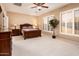 Spacious main bedroom with neutral walls, a ceiling fan, and plenty of natural light at 23318 N Las Positas Ct, Sun City West, AZ 85375