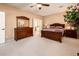 Comfortable main bedroom showcasing carpet floors, neutral walls, ceiling fan, and wood furniture at 23318 N Las Positas Ct, Sun City West, AZ 85375