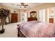 Inviting main bedroom featuring a large bed and ample furniture with ensuite bathroom access at 23318 N Las Positas Ct, Sun City West, AZ 85375