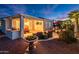 Outdoor patio area featuring desert landscaping, outdoor seating, and exterior lighting for relaxing evenings at 23318 N Las Positas Ct, Sun City West, AZ 85375