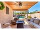 Inviting covered back patio with comfortable seating and view of the pool and waterfall feature at 23402 N 22Nd Way, Phoenix, AZ 85024