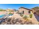 Backyard view featuring a pool, hot tub, and desert landscaping with mature cactus and succulents at 23402 N 22Nd Way, Phoenix, AZ 85024