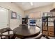 Bonus room featuring a round table, leather chairs, and a variety of shelving at 23402 N 22Nd Way, Phoenix, AZ 85024