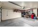 Spacious garage interior with shelving, overhead lighting, and an automatic door opener at 23402 N 22Nd Way, Phoenix, AZ 85024