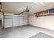 Clean garage interior with closed garage door, automatic door opener, and built in shelving at 23402 N 22Nd Way, Phoenix, AZ 85024