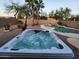 Inviting hot tub and pool in a landscaped backyard with rock features and desert landscaping at 23402 N 22Nd Way, Phoenix, AZ 85024