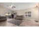 Bright living room featuring a large window, neutral paint, tile floors, and a ceiling fan at 23402 N 22Nd Way, Phoenix, AZ 85024