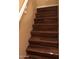 Interior staircase featuring hardwood treads and white railing detail at 25646 W Elwood St, Buckeye, AZ 85326