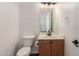 Cozy bathroom with a vanity, toilet, and a mirror with overhead lighting at 25792 W Burgess Ln, Buckeye, AZ 85326