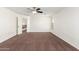 Upstairs bedroom with neutral carpet, a ceiling fan, and a window at 25792 W Burgess Ln, Buckeye, AZ 85326