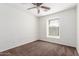 Cozy bedroom with neutral carpet, ceiling fan, and a window with blinds at 25792 W Burgess Ln, Buckeye, AZ 85326