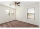 Bright bedroom with a ceiling fan, natural light, and carpet flooring at 25792 W Burgess Ln, Buckeye, AZ 85326