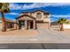 Charming two-story home featuring a stucco exterior, tile roof, covered porch, and well-maintained landscaping at 25792 W Burgess Ln, Buckeye, AZ 85326