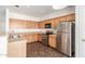 Bright kitchen with stainless steel appliances and light wood cabinets at 25792 W Burgess Ln, Buckeye, AZ 85326