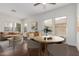 Bright living room featuring hardwood floors, tan-colored furniture, dining table, and recessed lighting at 25792 W Burgess Ln, Buckeye, AZ 85326