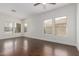 Living room featuring hardwood floors, recessed lighting, white walls, and a ceiling fan at 25792 W Burgess Ln, Buckeye, AZ 85326