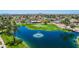 A scenic aerial view of the pond with water fountain, golf course, and community at 25822 S Eastlake Dr, Sun Lakes, AZ 85248