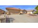 Single-story home with a two-car garage, long driveway, and desert landscaping at 25822 S Eastlake Dr, Sun Lakes, AZ 85248