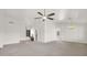 Open-concept living room featuring a ceiling fan and arched doorway at 25822 S Eastlake Dr, Sun Lakes, AZ 85248