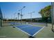 This photo showcases pickleball courts with vibrant blue surfaces and green surroundings against a clear blue sky at 25822 S Eastlake Dr, Sun Lakes, AZ 85248