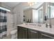 Well-lit bathroom featuring a double sink vanity, shower-tub combo, and neutral color palette at 25951 N 106Th Dr, Peoria, AZ 85383