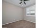 This bedroom features carpet floors, a ceiling fan, and window with plantation shutters at 25951 N 106Th Dr, Peoria, AZ 85383