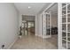 Spacious foyer with tile flooring, leading to the living areas and featuring stylish French doors at 25951 N 106Th Dr, Peoria, AZ 85383