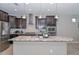 Stylish kitchen island with pendant lighting, granite countertops, and stainless steel appliances at 25951 N 106Th Dr, Peoria, AZ 85383