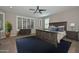 The main bedroom features a ceiling fan, large windows with plantation shutters, and a spacious walk-in closet at 25951 N 106Th Dr, Peoria, AZ 85383