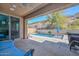 Covered patio area leading to a refreshing private pool, perfect for outdoor relaxation at 25951 N 106Th Dr, Peoria, AZ 85383