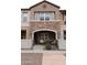 Charming townhome featuring a stone facade, covered porch, and well-manicured landscaping, offering inviting curb appeal at 2670 S Voyager Dr # 108, Gilbert, AZ 85295