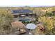 Expansive aerial view of the house showcasing its desert landscaping, patio, solar panels, and outdoor kitchen at 27641 N 74Th St, Scottsdale, AZ 85266