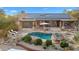 Stunning aerial view of a house showing off the pool, solar panels, patio, and professionally landscaped yard at 27641 N 74Th St, Scottsdale, AZ 85266