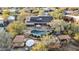 A high angle aerial view of backyard with a luxurious pool, spa, patio, and well-manicured desert landscaping at 27641 N 74Th St, Scottsdale, AZ 85266