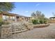 Beautiful stone steps with lighting lead to the home's outdoor living spaces and desert surroundings at 27641 N 74Th St, Scottsdale, AZ 85266