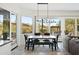 Open dining area with large windows, a modern chandelier, and a table perfect for Gathering gatherings at 27641 N 74Th St, Scottsdale, AZ 85266