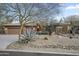 Single-story home with desert landscaping featuring gravel, rocks, and succulent plants at 27641 N 74Th St, Scottsdale, AZ 85266