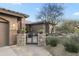 Charming home featuring a gated entry, stone accents, a tile roof, and lush desert landscaping at 27641 N 74Th St, Scottsdale, AZ 85266