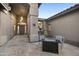 Inviting front porch with decorative lighting, tile flooring, and outdoor seating next to the entryway at 27641 N 74Th St, Scottsdale, AZ 85266