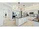 Bright kitchen featuring white cabinetry, stainless steel appliances, pendant lighting and a center island with seating at 27641 N 74Th St, Scottsdale, AZ 85266