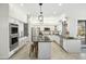 Bright kitchen featuring white cabinetry, stainless steel appliances, pendant lighting and a center island with seating at 27641 N 74Th St, Scottsdale, AZ 85266