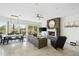 Living room features a stone fireplace, tile flooring, dining table and sliding glass doors to outdoor patio at 27641 N 74Th St, Scottsdale, AZ 85266