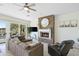 Cozy living room featuring a stone fireplace, tile flooring and plush sectional couch at 27641 N 74Th St, Scottsdale, AZ 85266